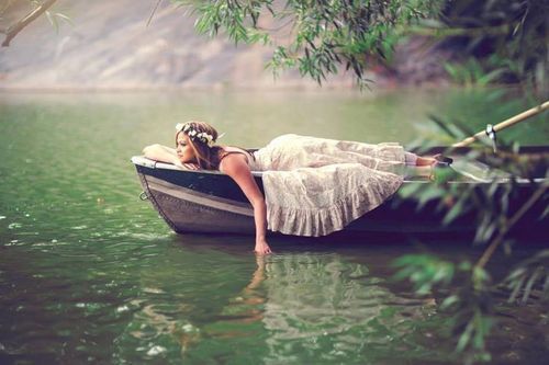 Девушка, плывущая в лодке по реке