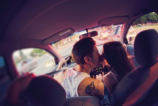 парень с тату и девушка целуются в автомобиле
